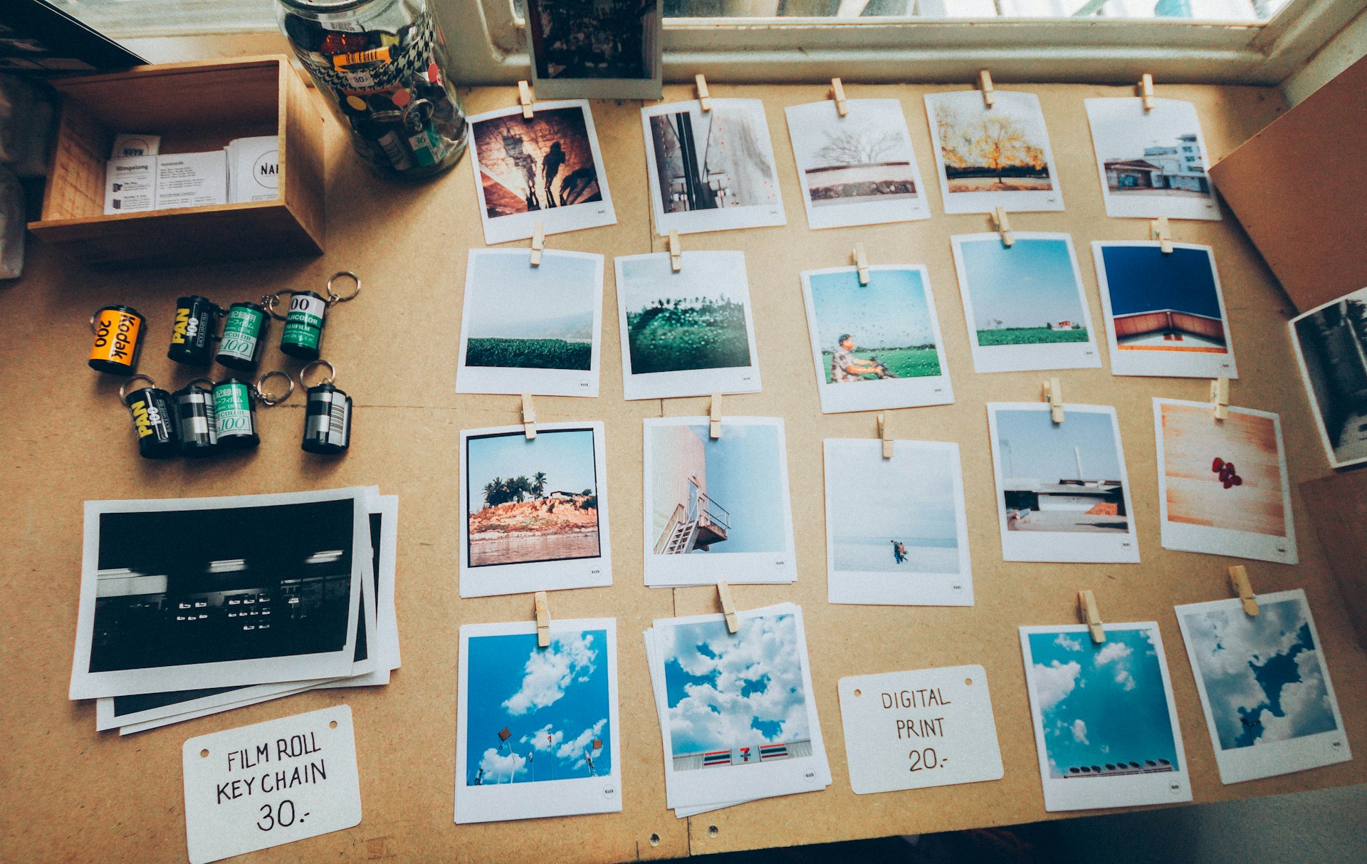 Assorted photos on beige wooden table. 